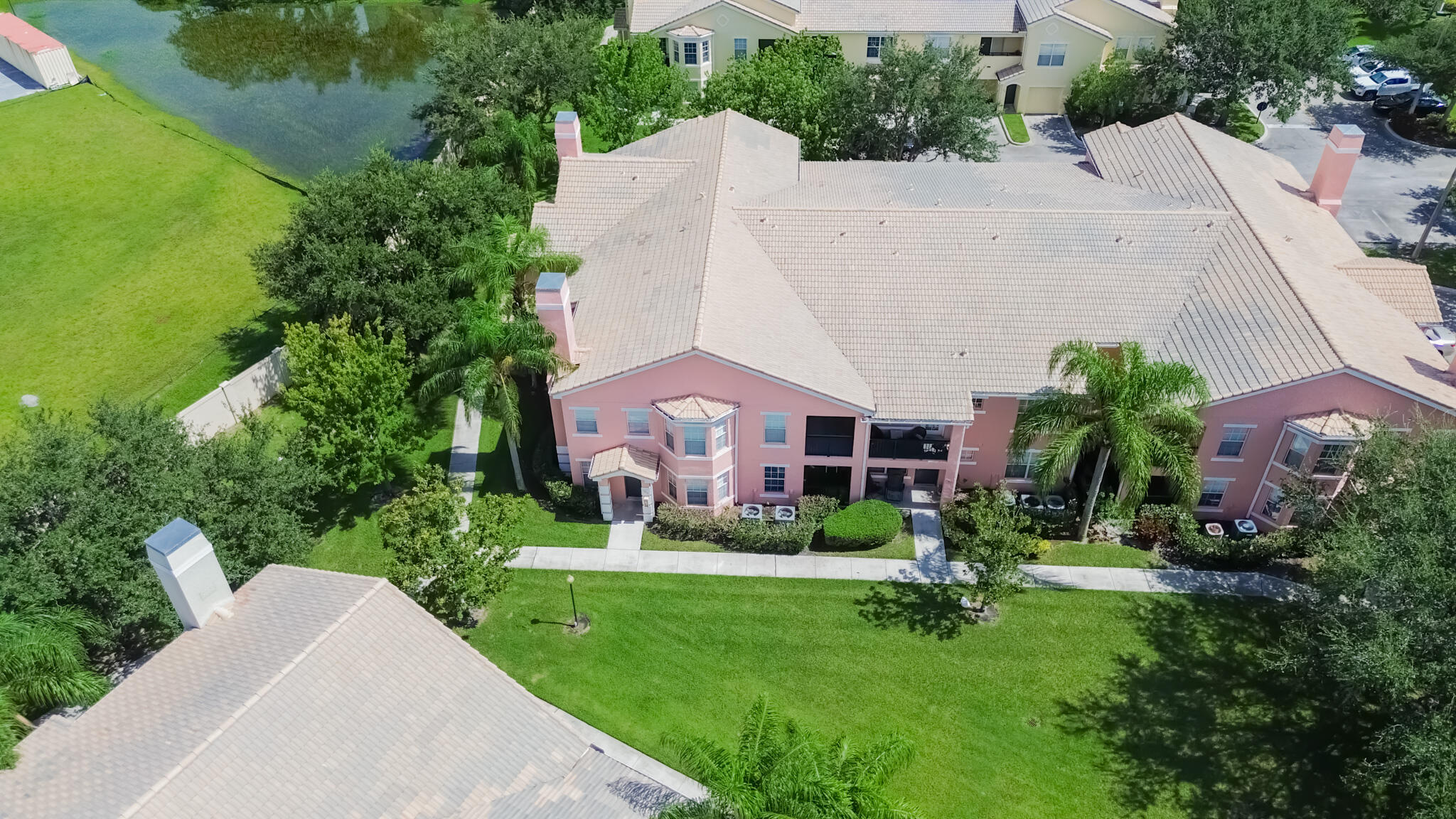 168 Southwest Peacock Boulevard, Unit 35103 Port St. Lucie, FL 34986 - Photo 23 of 43 a aerial view of a house with a yard and plants