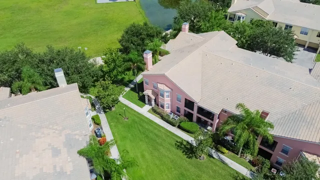 an aerial view of a house with a yard and lake view
