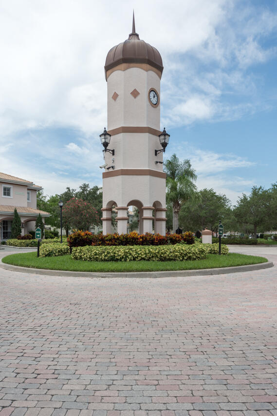 168 Southwest Peacock Boulevard, Unit 35103 Port St. Lucie, FL 34986 - Photo 27 of 43 a front view of a house with a yard and trees