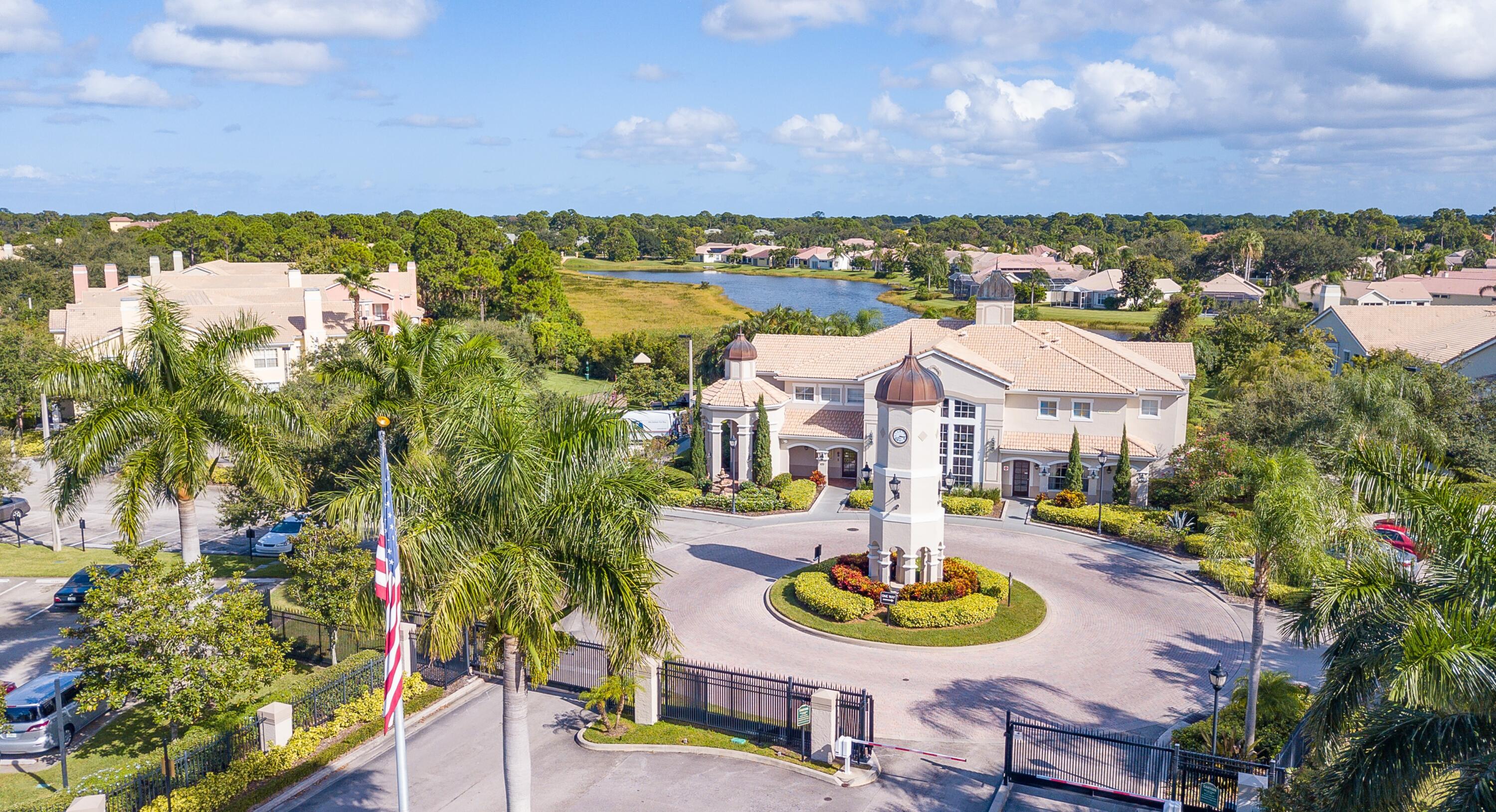 168 Southwest Peacock Boulevard, Unit 35103 Port St. Lucie, FL 34986 - Photo 28 of 43 a front view of a house with a yard and lake view