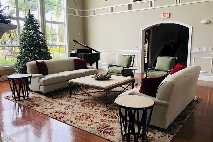 168 Southwest Peacock Boulevard, Unit 35103 Port St. Lucie, FL 34986 - Photo 29 of 43 a living room with furniture and a fireplace