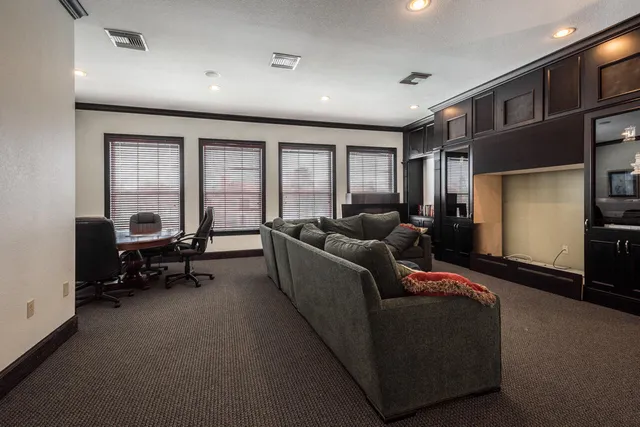 a living room with furniture and a flat screen tv with wooden floor
