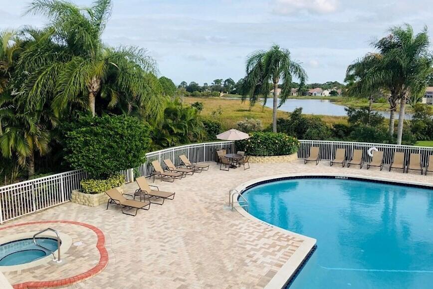 168 Southwest Peacock Boulevard, Unit 35103 Port St. Lucie, FL 34986 - Photo 38 of 43 swimming pool view with a seating space