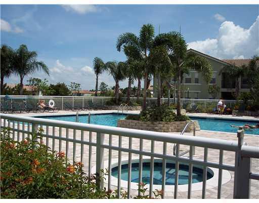 168 Southwest Peacock Boulevard, Unit 35103 Port St. Lucie, FL 34986 - Photo 42 of 43 a view of swimming pool with lake view