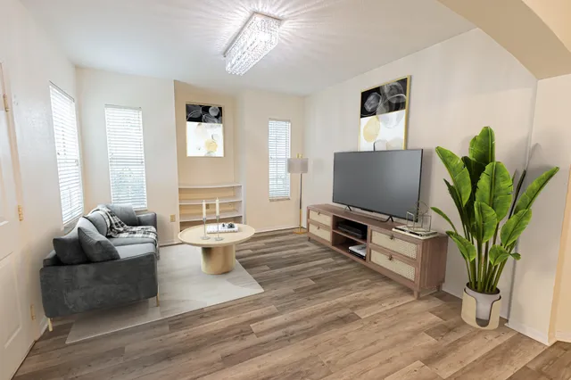 a living room with furniture and a flat screen tv