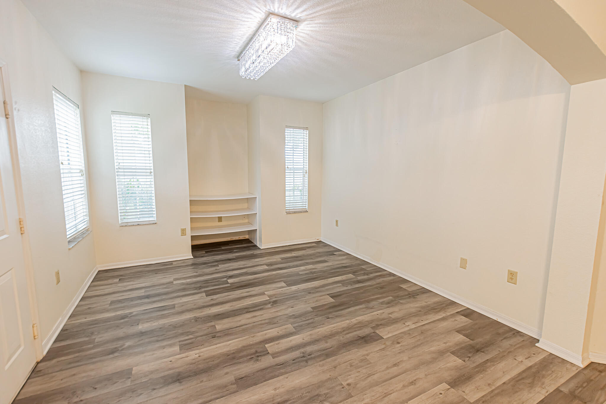 168 Southwest Peacock Boulevard, Unit 35103 Port St. Lucie, FL 34986 - Photo 7 of 43 a view of empty room with wooden floor and fan