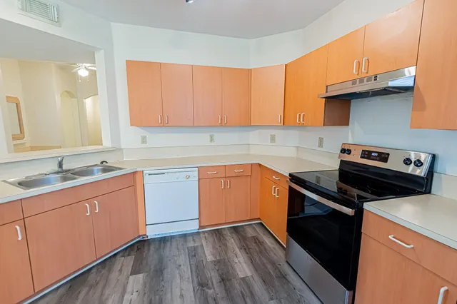 a kitchen with a sink stove and cabinets