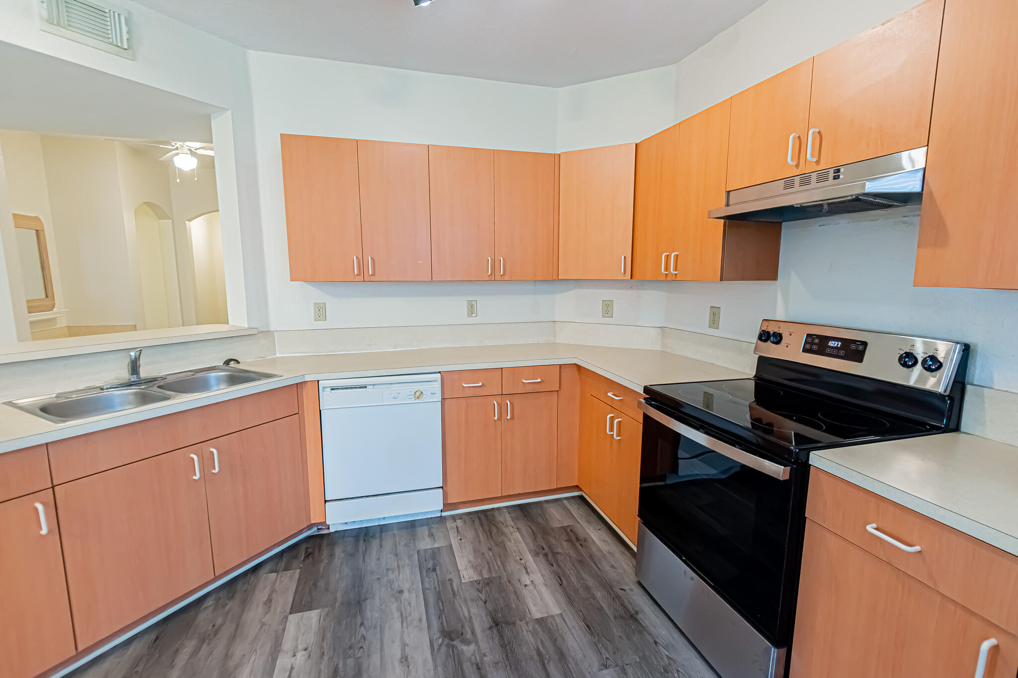 168 Southwest Peacock Boulevard, Unit 35103 Port St. Lucie, FL 34986 - Photo 9 of 43 a kitchen with a sink stove and cabinets