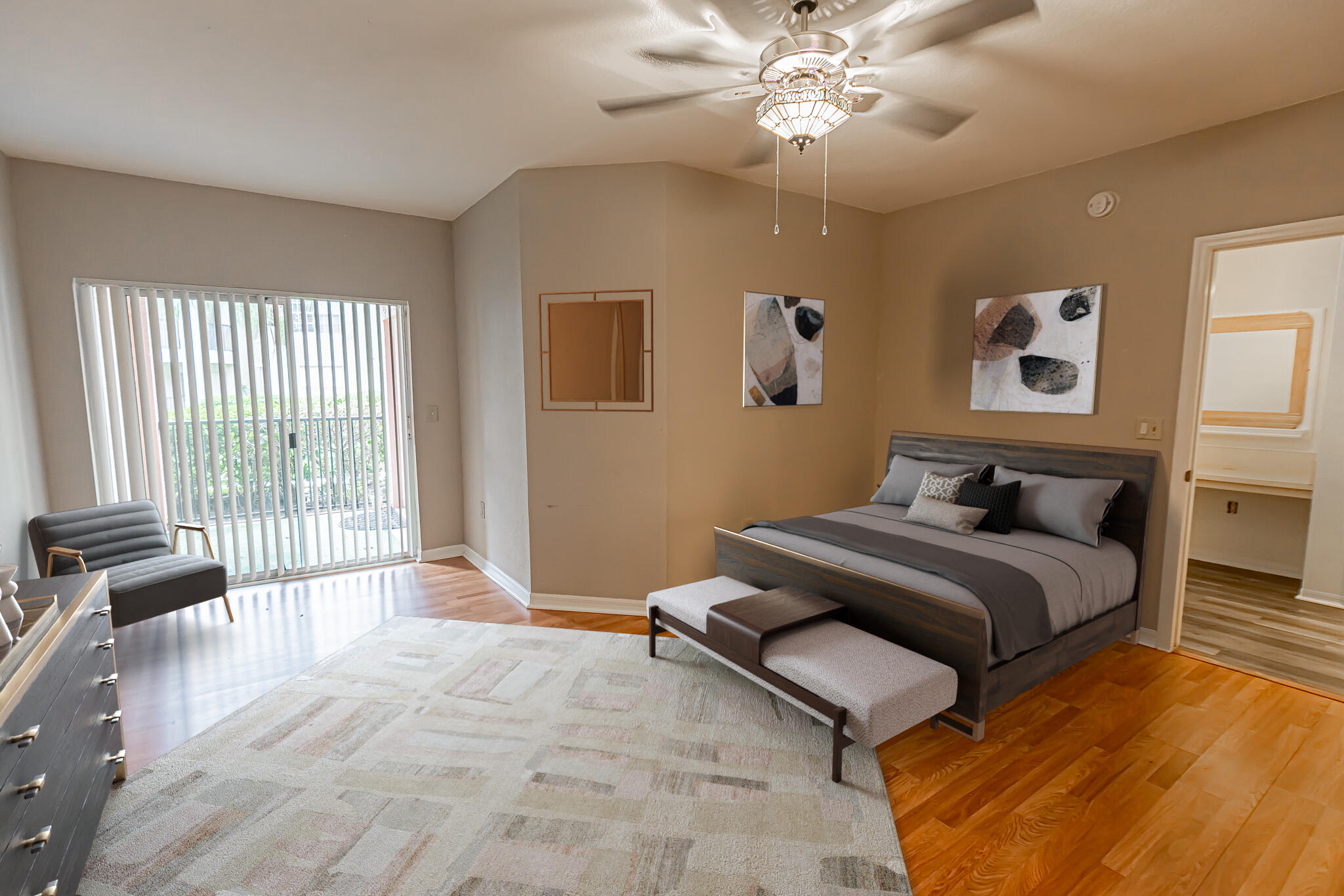 168 Southwest Peacock Boulevard, Unit 35103 Port St. Lucie, FL 34986 - Photo 10 of 43 a spacious bedroom with a bed and a chandelier