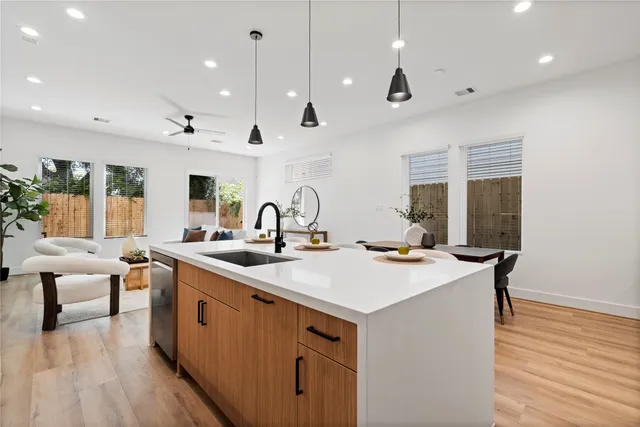 a living room with furniture a window and a potted plant
