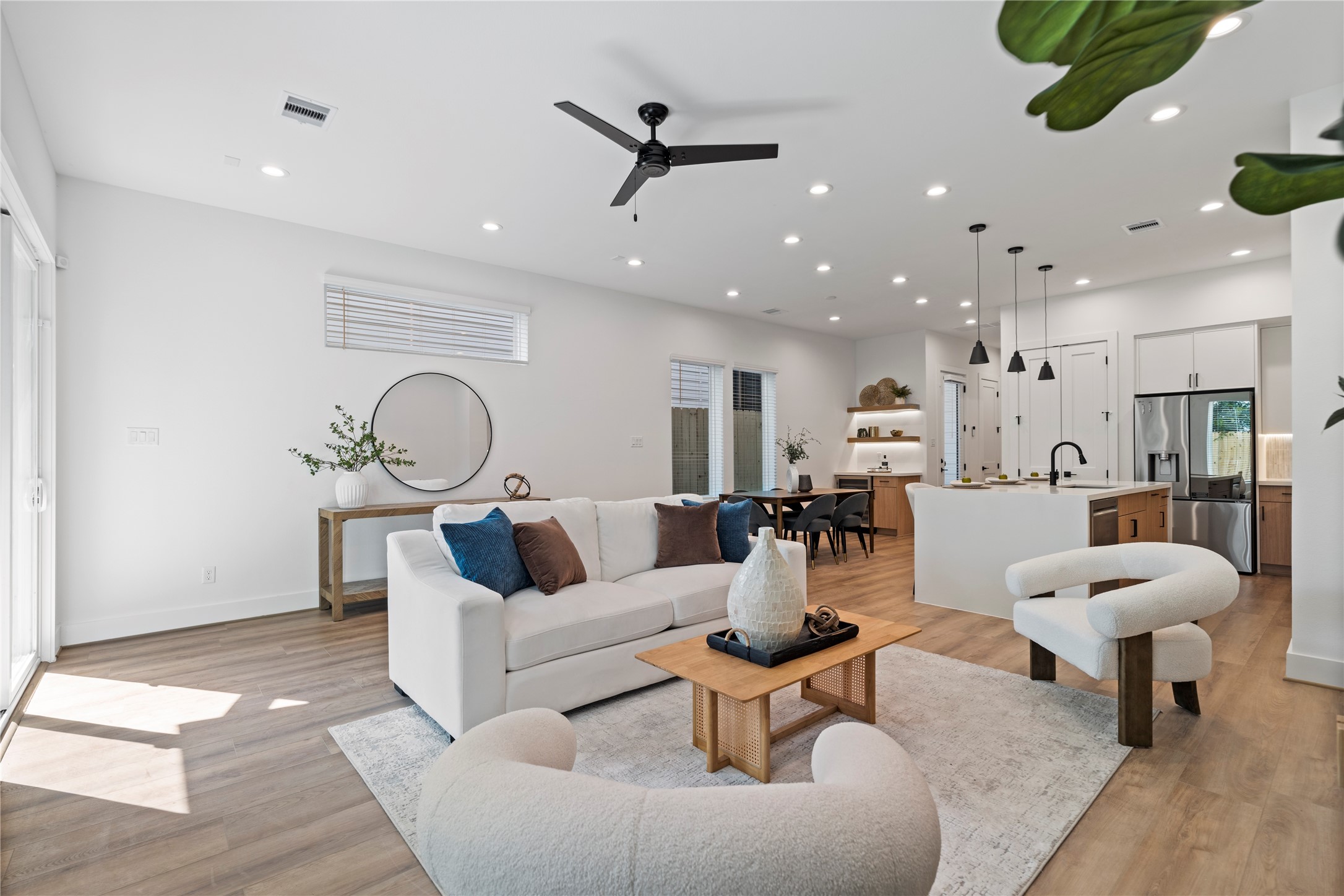 2706 Fox Street Houston, TX 77003 - Photo 15 of 39 a living room with furniture and a dining table with wooden floor