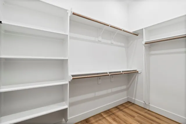 an empty room with a window and ceiling fan