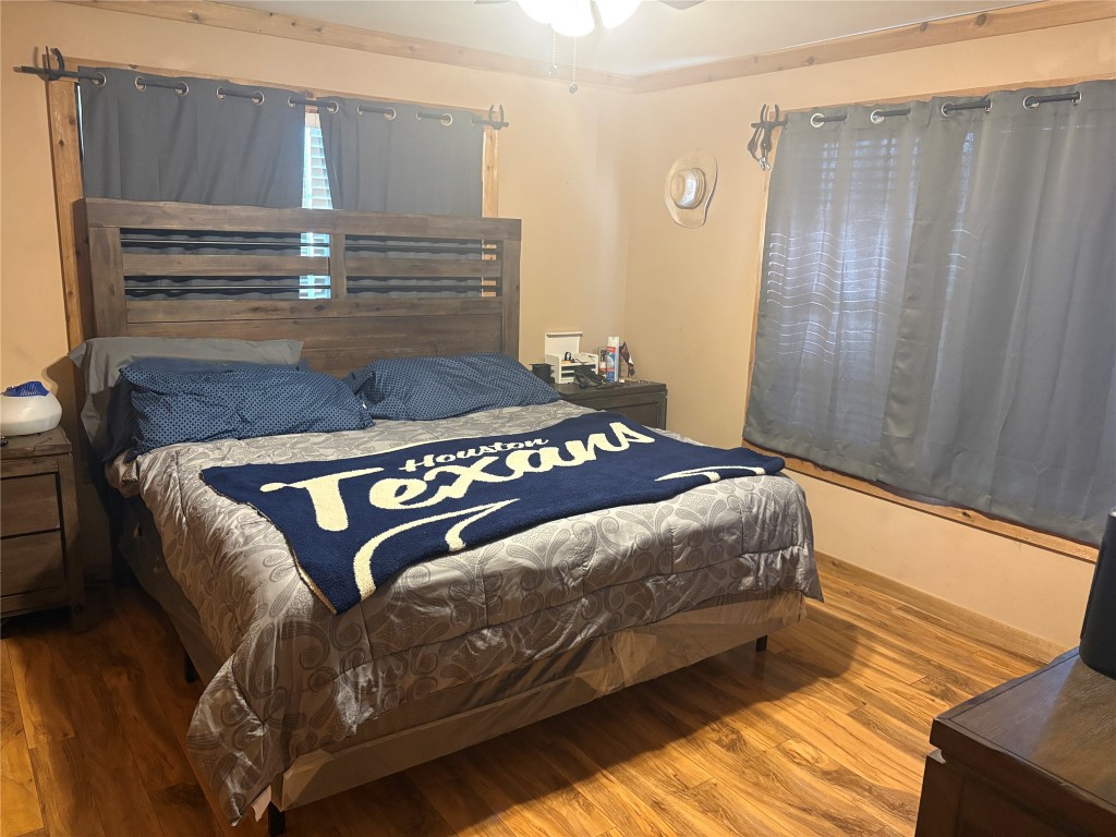 2291 State Highway 71 Columbus, TX 78934 - Photo 6 of 12 a bedroom with bed and wooden floor