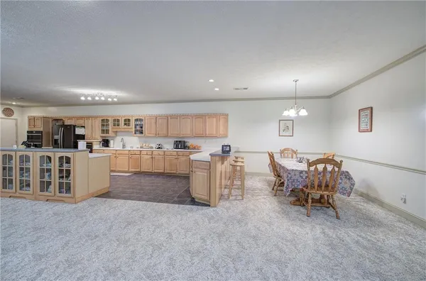 a kitchen with stainless steel appliances granite countertop a refrigerator and a stove top oven