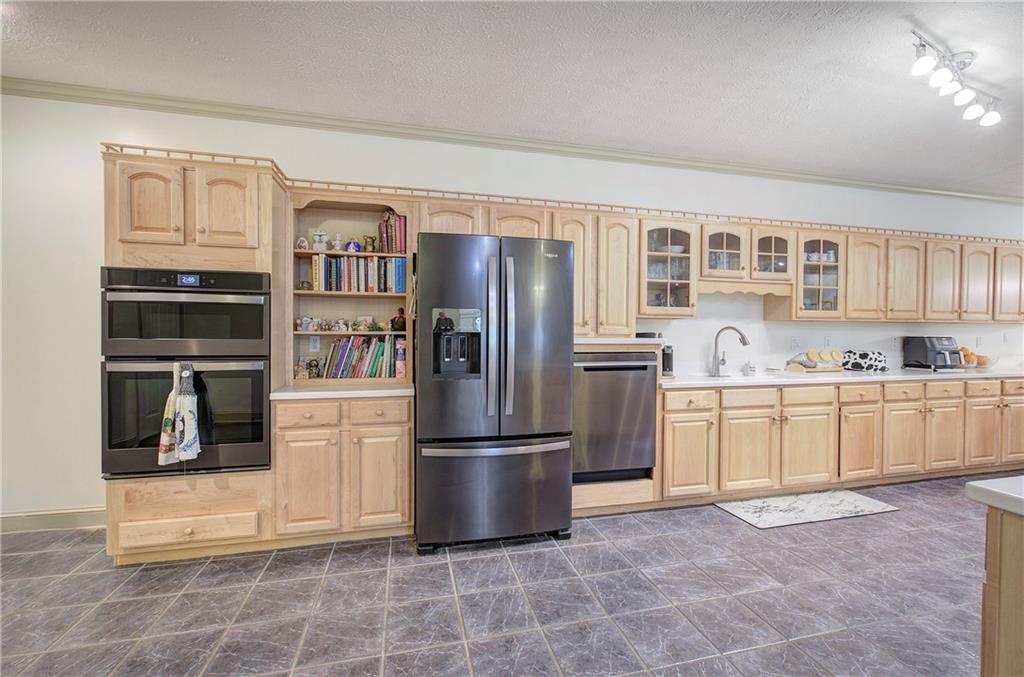 265 Evans Drive Buchanan, GA 30113 - Photo 21 of 123 a kitchen with stainless steel appliances granite countertop a refrigerator and a stove top oven