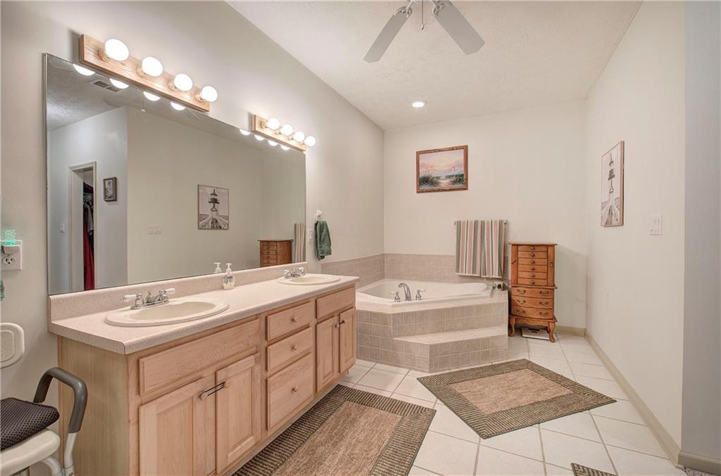 265 Evans Drive Buchanan, GA 30113 - Photo 35 of 123 a spacious bathroom with a double vanity sink a mirror and a bathtub