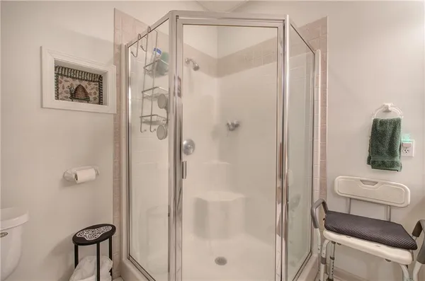 a view of a dry yard with a barn and large trees