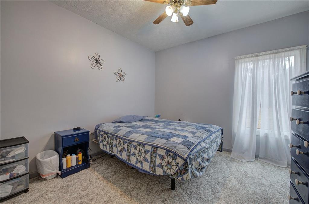 265 Evans Drive Buchanan, GA 30113 - Photo 38 of 123 a bedroom with a bed and a chandelier