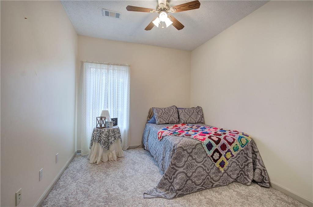 265 Evans Drive Buchanan, GA 30113 - Photo 41 of 123 a bedroom with a bed and a chandelier