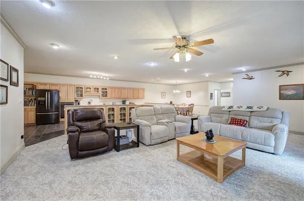 a dining room with furniture and kitchen view