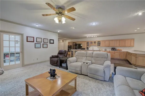 a large kitchen with stainless steel appliances granite countertop a lot of counter space and wooden floors