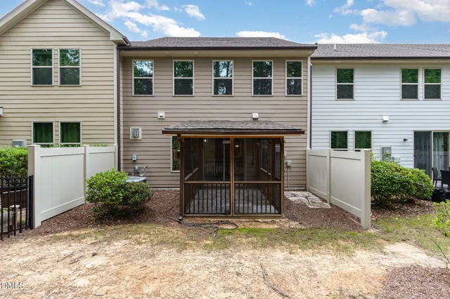 a view of a house with a yard and potted plants