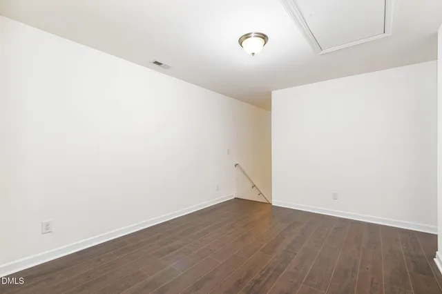 a view of a room with wooden floor
