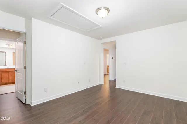 a view of a room with wooden floor