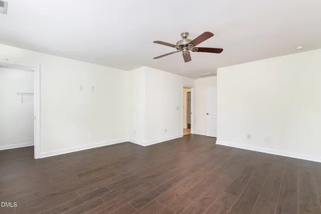 a view of a big room with wooden floor and closet in a room