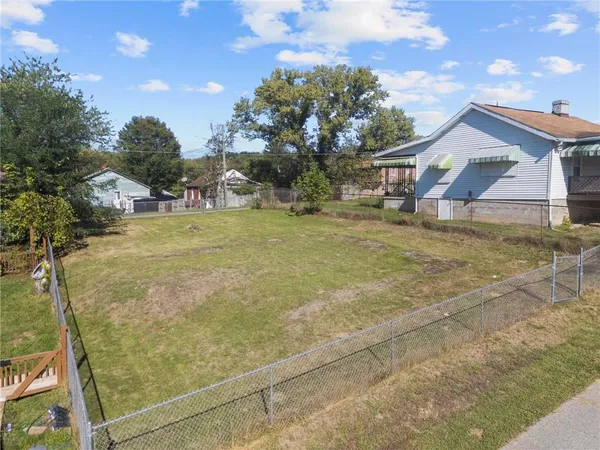 a view of a house with a yard and garage