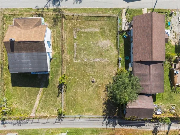 an aerial view of residential house with a outdoor space