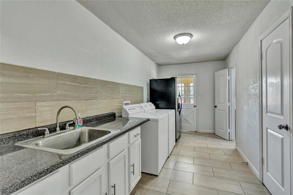 4405 Ray White Road Fort Worth, TX 76244 - Photo 19 of 36 Oversized laundry/mudroom connects to hallway, primary bathroom, and sunroom
