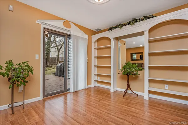 a view of an entryway with wooden floor and a potted plant