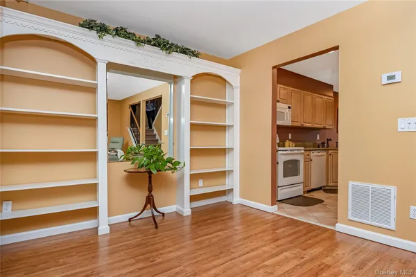 a view of a livingroom with wooden floor and a cabinet