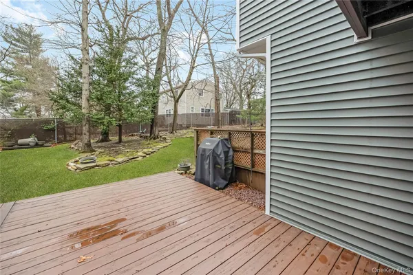 a view of a backyard with wooden fence