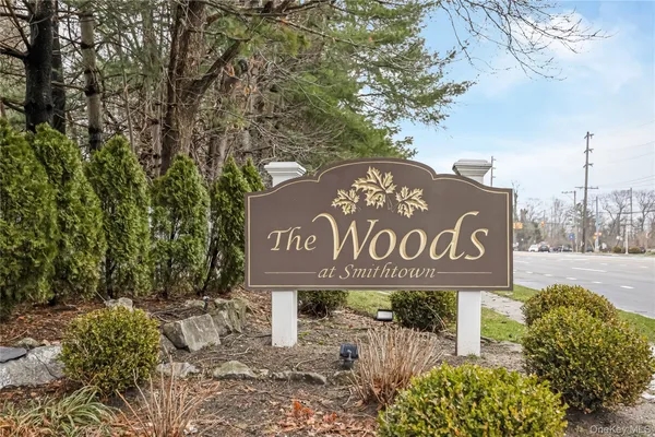 a street sign that is sitting on a brick wall