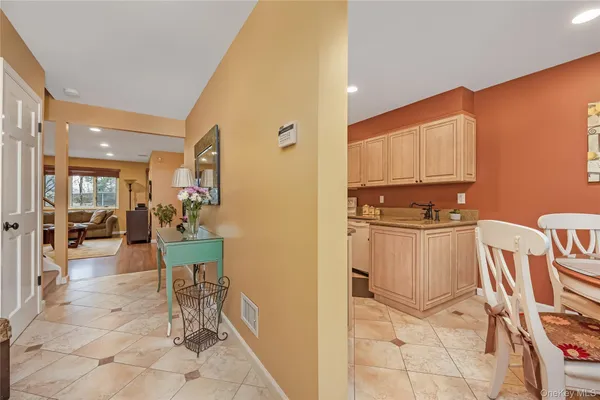 a dining room with furniture and a kitchen view
