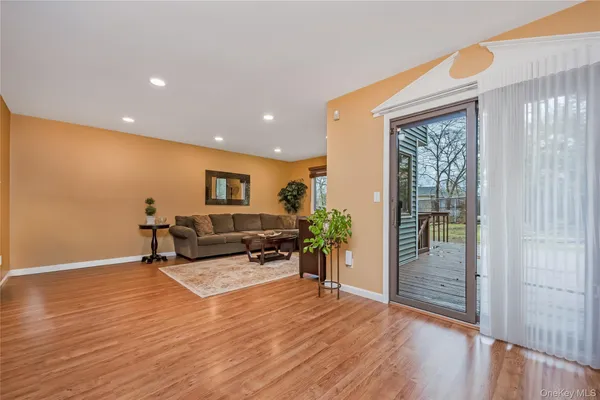 a view of a living room filled with furniture and wooden floor