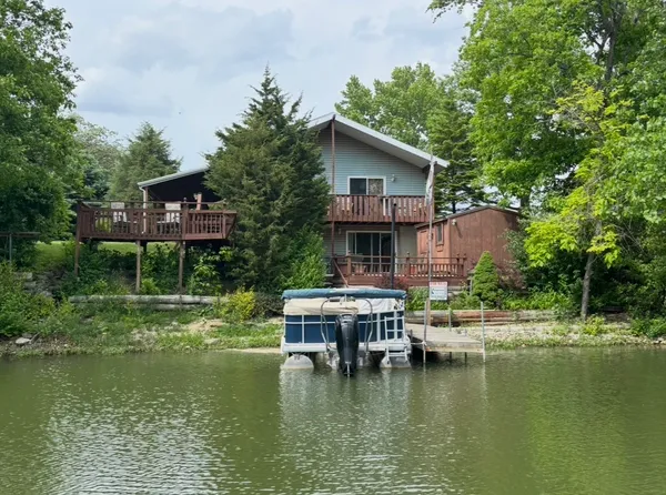 a house with swimming pool in front of it