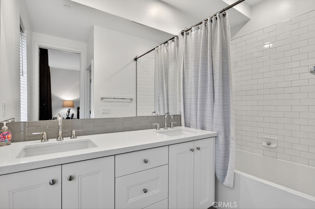 985 Doheny Way Dana Point, CA 92629 - Photo 20 of 21 a bathroom with a double vanity sink and a mirror