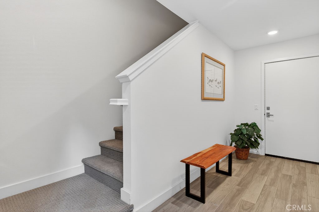 985 Doheny Way Dana Point, CA 92629 - Photo 3 of 21 a bench sitting in a hallway with a dinning room and bathroom