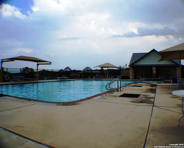 a view of swimming pool outdoor seating and city view