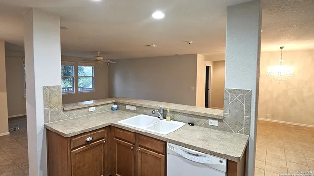 a bathroom with a granite countertop sink a mirror and a shower