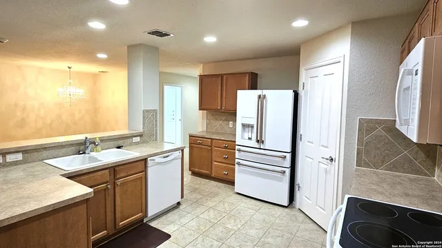 a kitchen with stainless steel appliances a refrigerator sink and cabinets