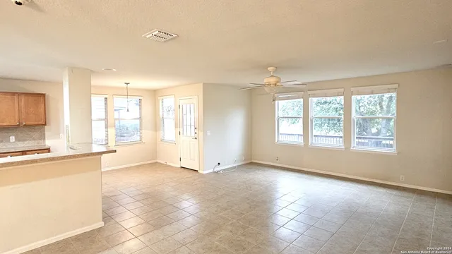 a view of a kitchen with a sink and a window