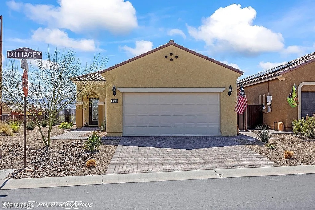 1304 Cottage Ridge Mesquite, NV 89034 - Photo 38 of 52 A well-maintained stucco home with a tile roof and a paver driveway offers inviting curb appeal.
