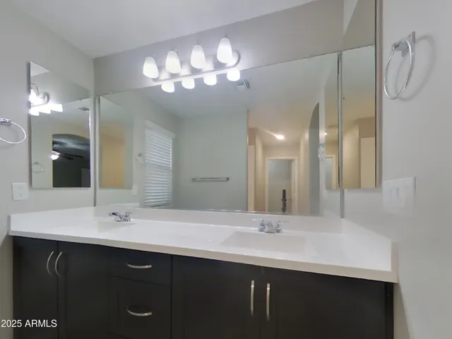 a large kitchen with stainless steel appliances granite countertop a refrigerator and a sink