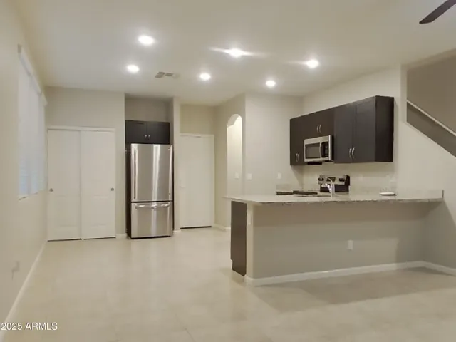 en empty room with ceiling fan and flat screen tv