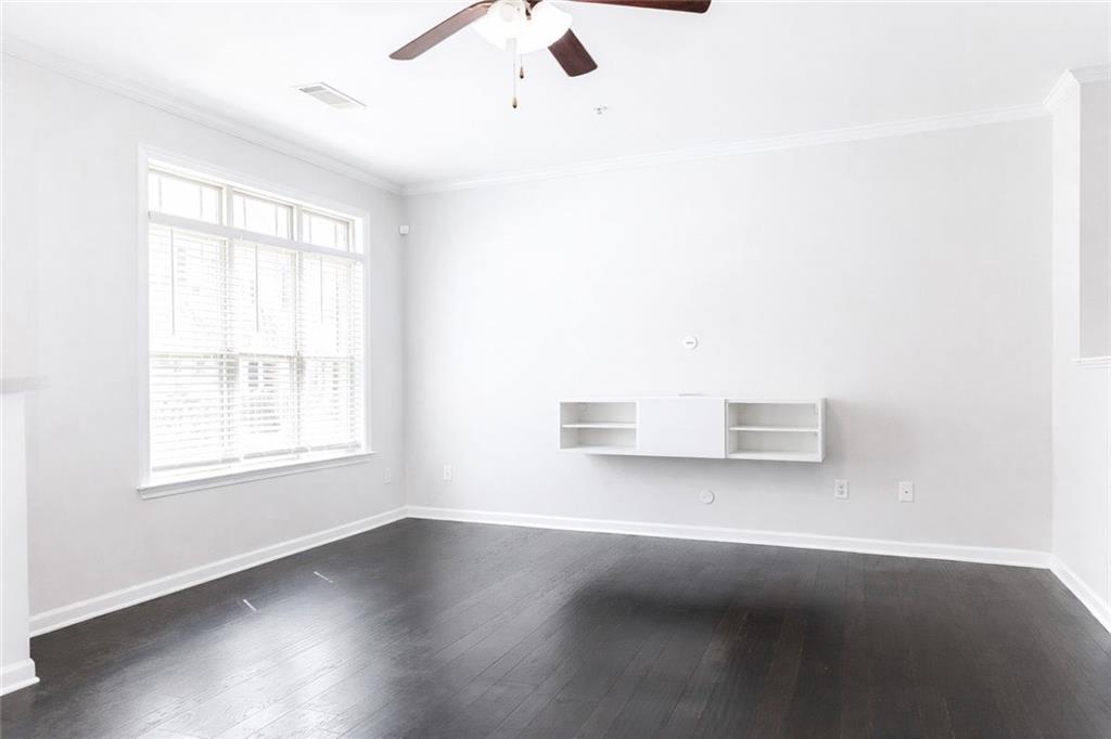 544 Ridge View Crossing Woodstock, GA 30188 - Photo 2 of 30 an empty room with wooden floor and windows