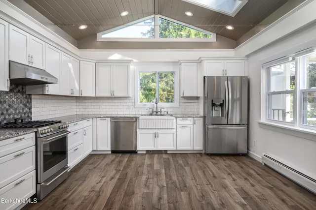 a kitchen with a sink a refrigerator and window